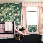 Une chambre d'enfants avec un accent brillant sur le mur et des rideaux à rayures roses